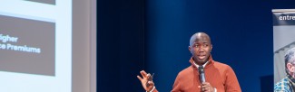 A man is presenting on a stage.
