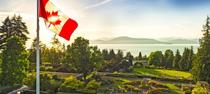 Canada flag over UBC Rose Garden looking north to the ocean and mountains