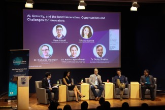 Panelists sitting on a stage
